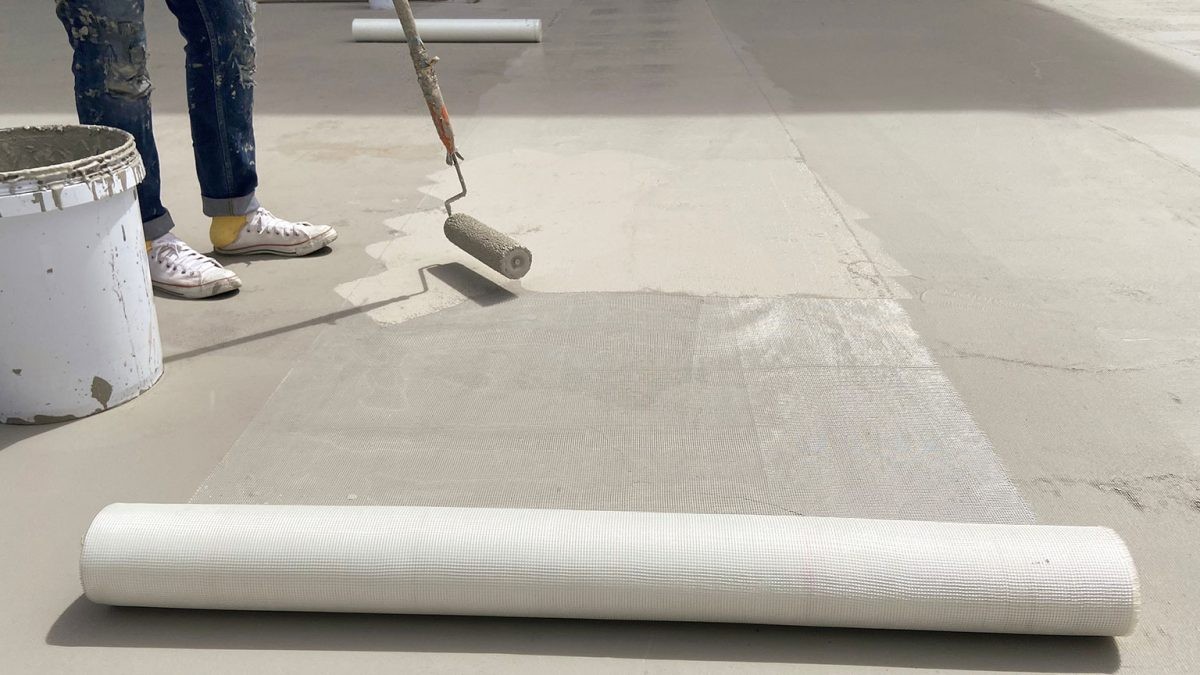 Acrylic roof coating being applied to residential roof surface